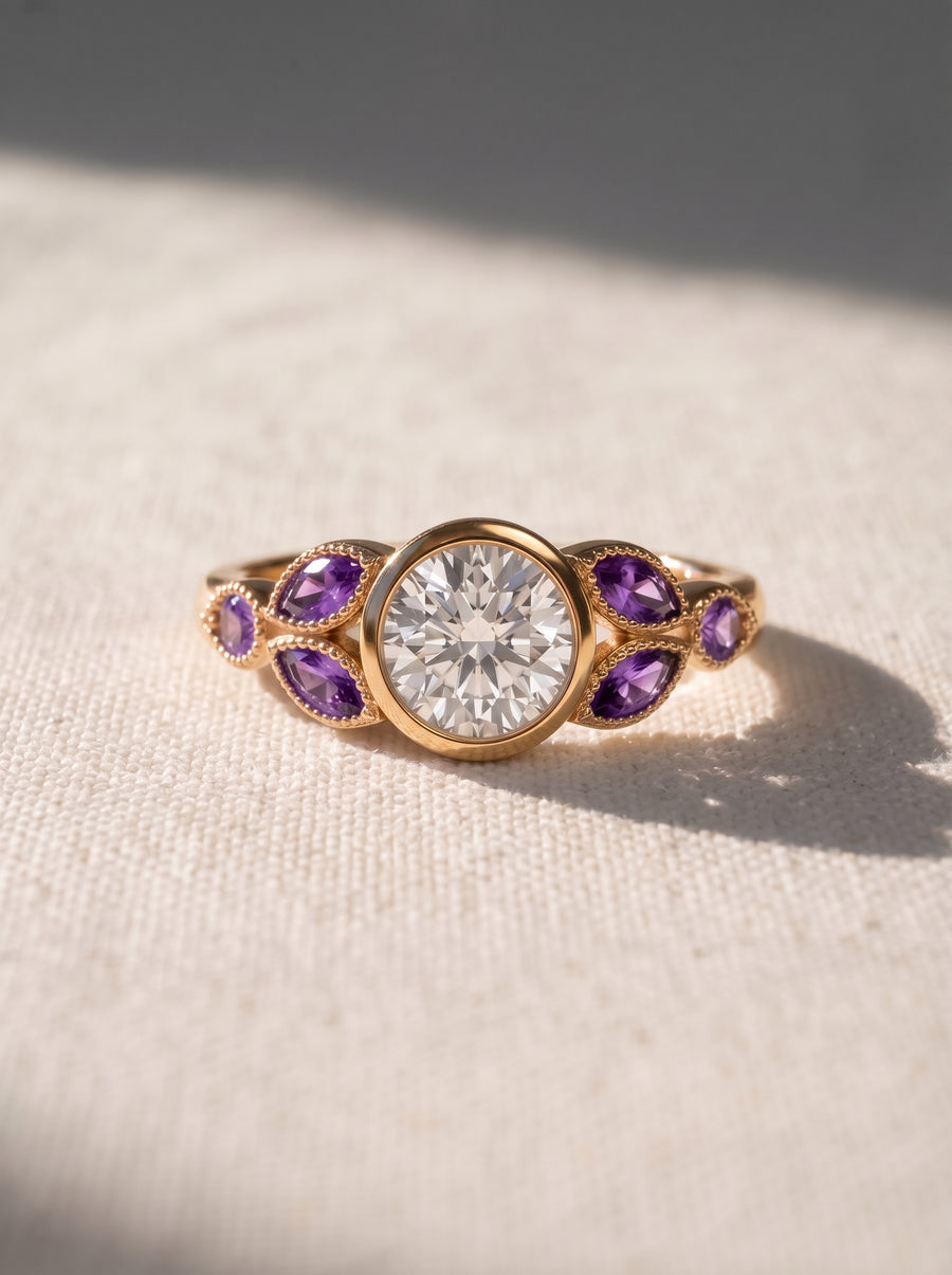 Gold engagement ring with a round center diamond and marquise-cut purple amethyst side stones.