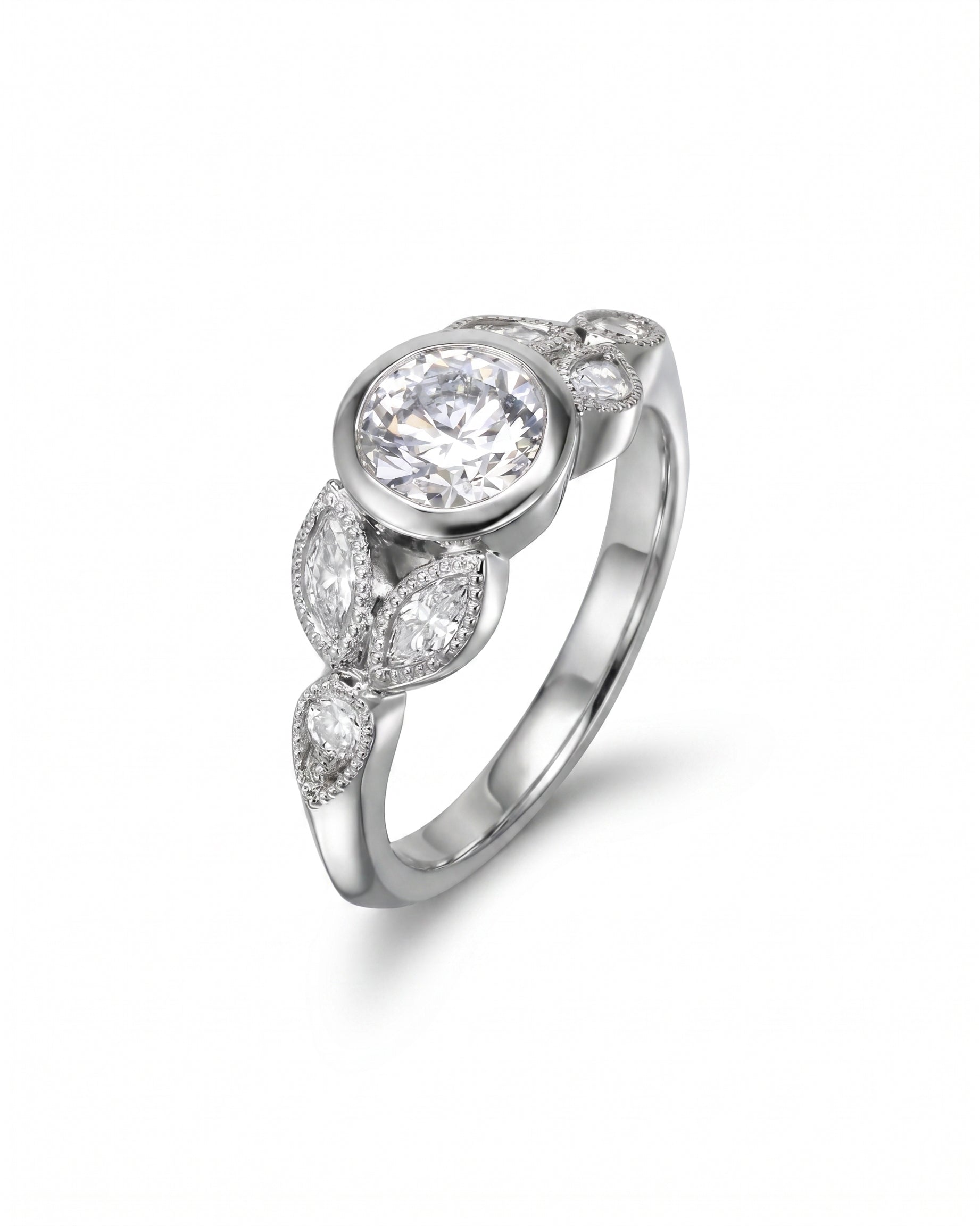 Silver bezel set diamond engagement ring with marquise and round side stones.