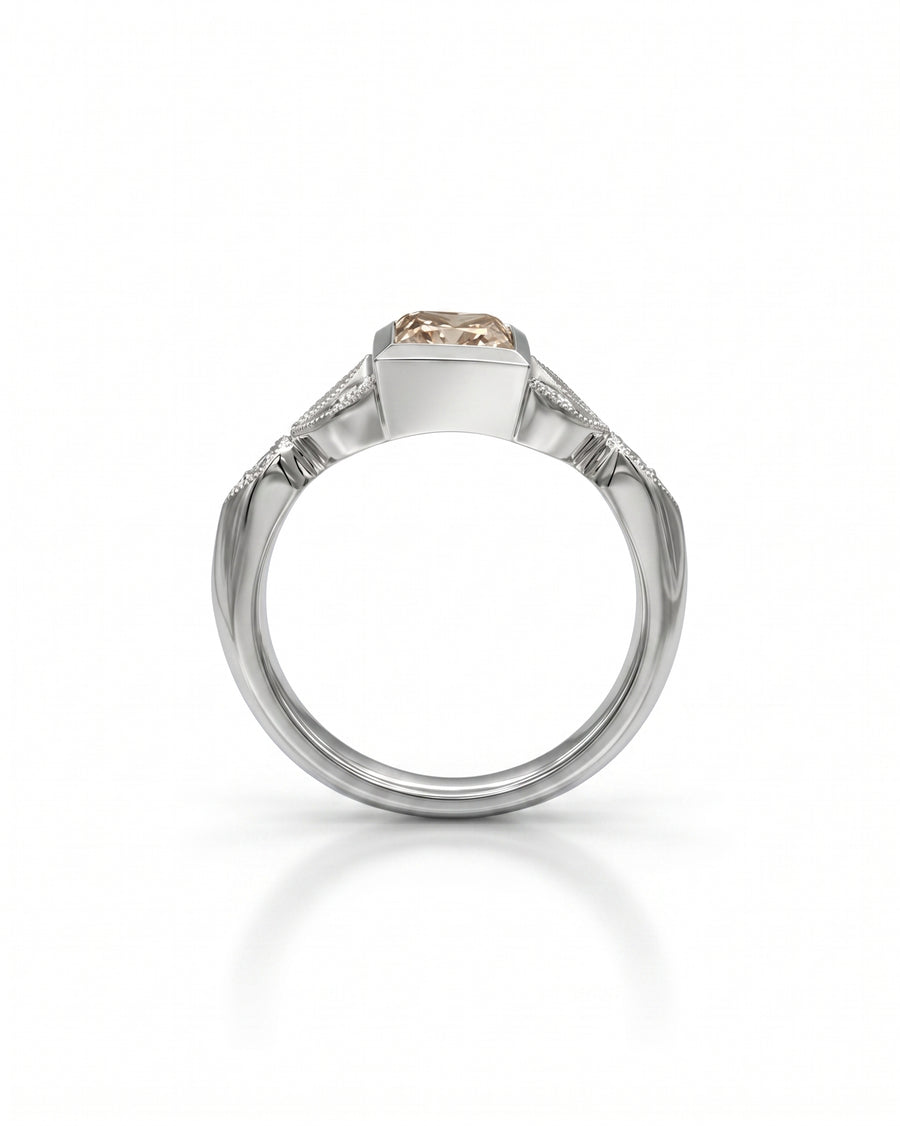 Platinum engagement ring with a vintage cappuccino diamond and side diamonds.