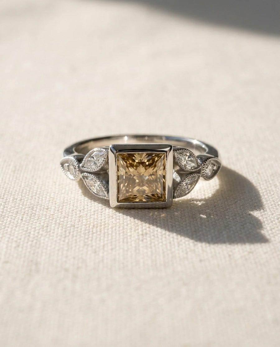 Platinum engagement ring with a princess-cut cappuccino diamond and marquise side stones.