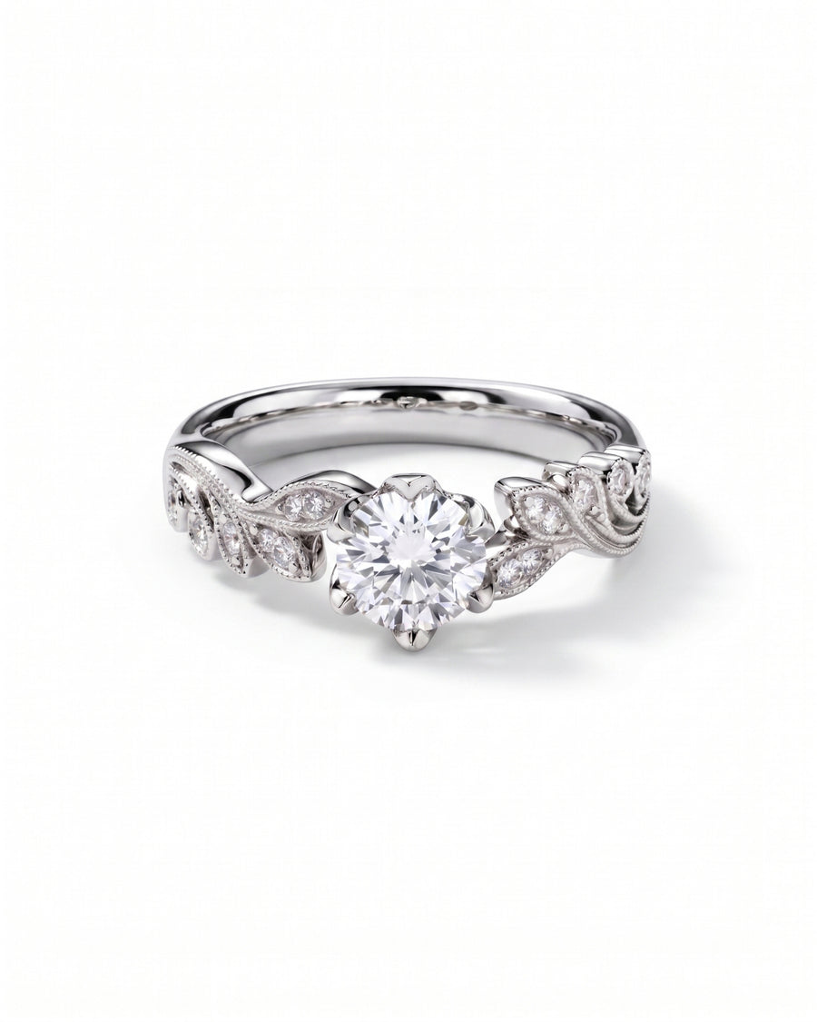 Silver ring with a round diamond center stone and leaf-shaped diamond accents.
