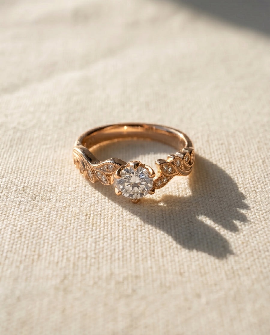 18ct rose gold engagement ring with a 0.5ct natural diamond and beaded leaf design.