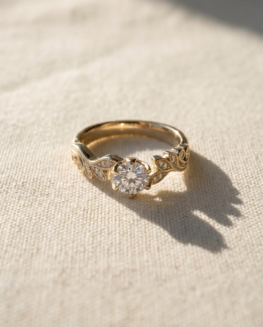 18ct yellow gold engagement ring with a 0.5ct natural diamond and beaded leaf design.