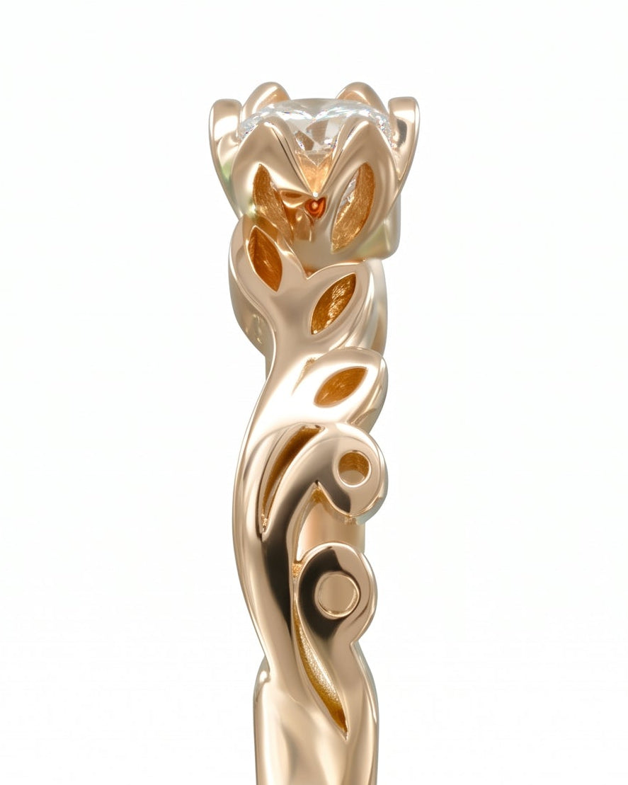 Gold engagement ring with a round diamond and leaf-motif band.