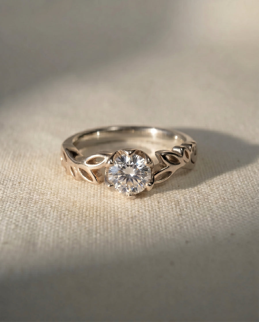 9ct white gold engagement ring with a round lab grown diamond and leaf band.