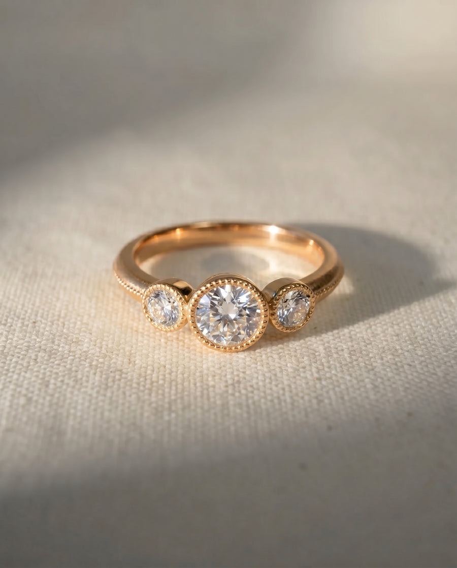9ct rose gold trilogy engagement ring with three round diamonds.