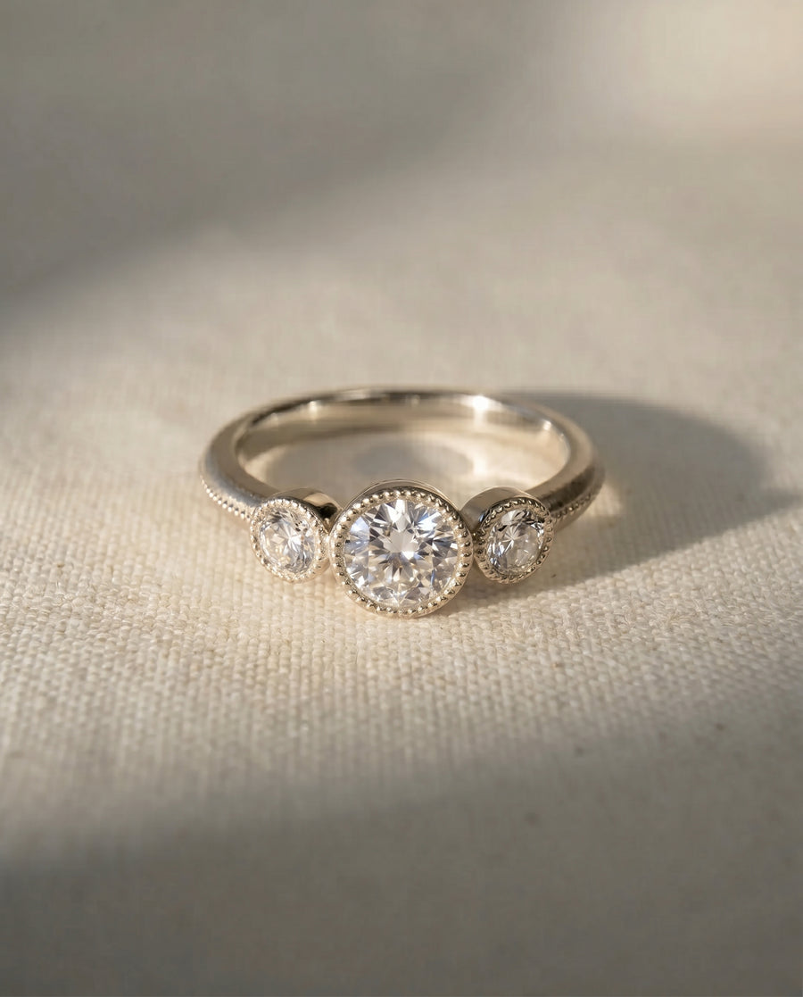 9ct white gold trilogy engagement ring with three round diamonds.