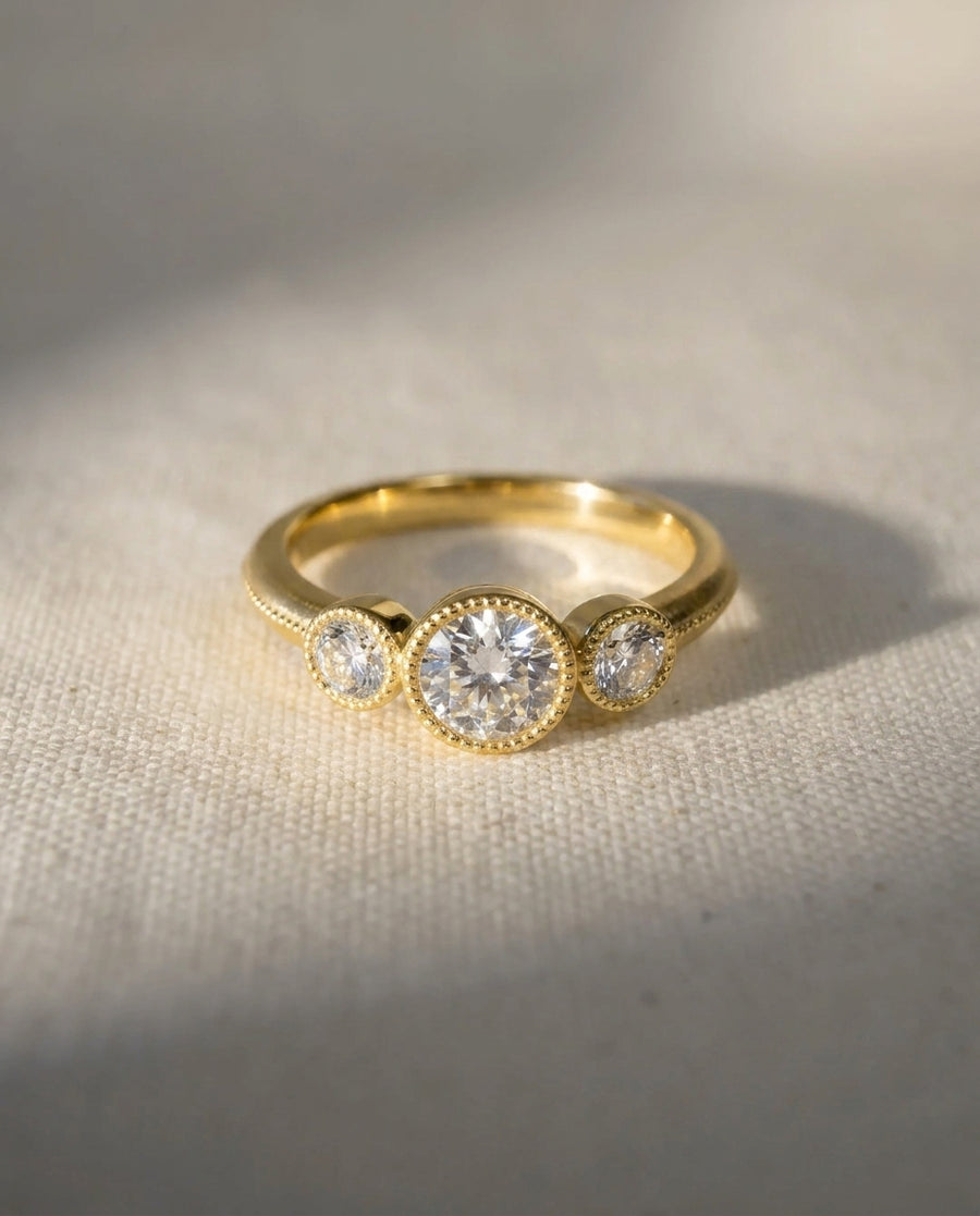 9ct yellow gold trilogy engagement ring with three round diamonds.