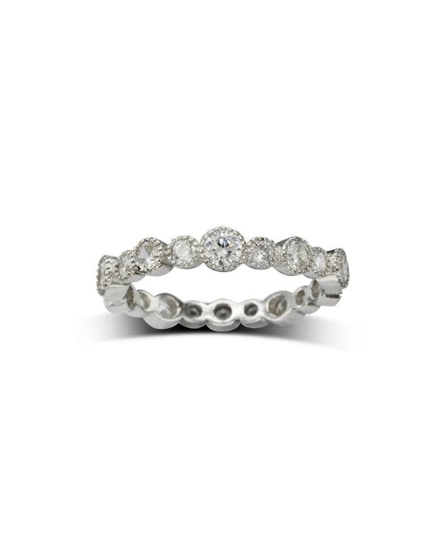 Silver eternity ring with round-cut diamonds in a bezel setting.