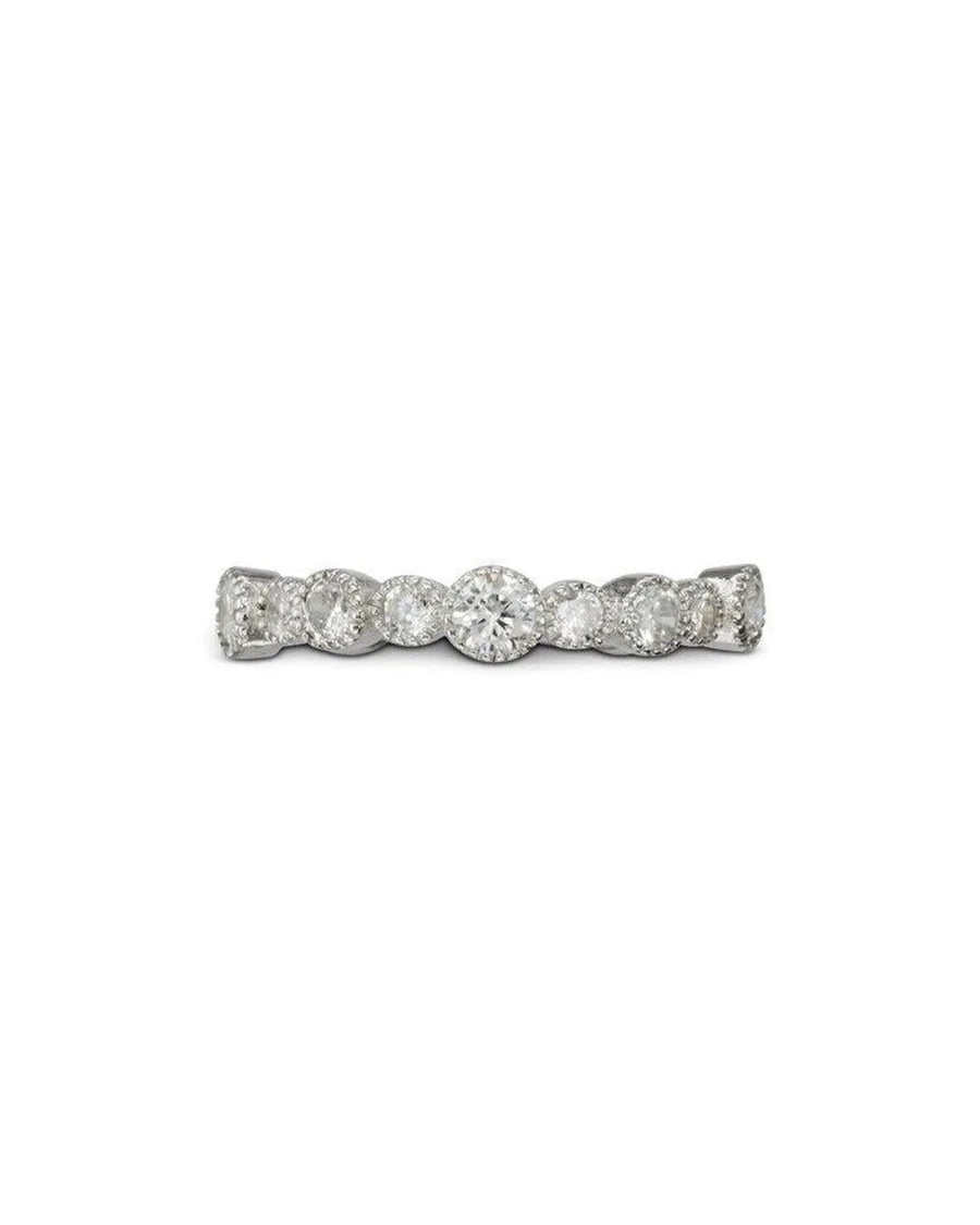 Silver eternity ring with round diamonds in varying sizes.