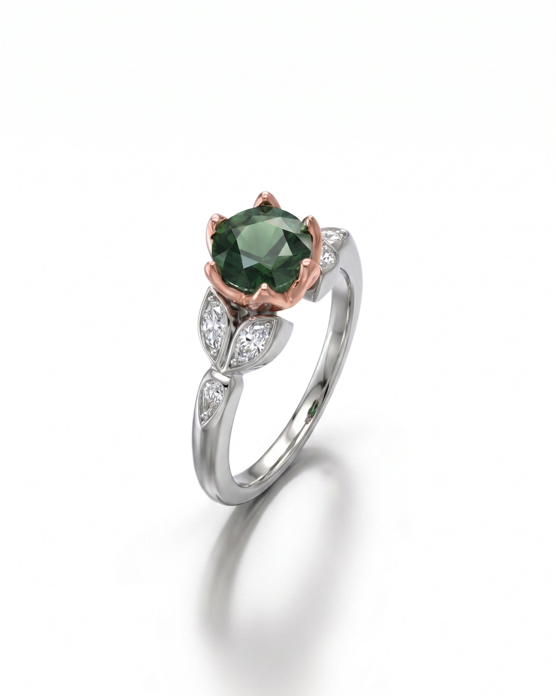 Silver and rose gold ring with an oval green diamond and leaf-shaped side diamonds.