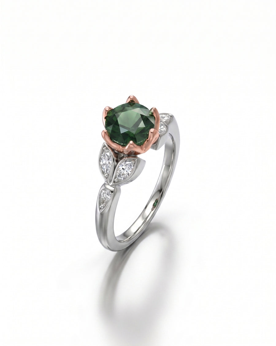 Silver and rose gold ring with an oval green diamond and leaf-shaped side diamonds.