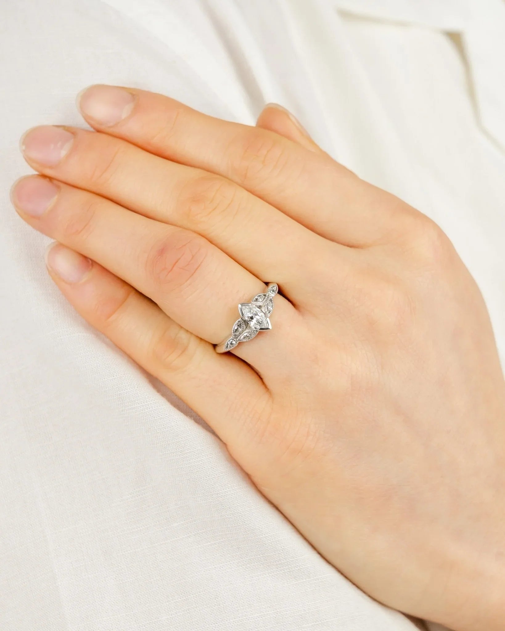 vintage marquise diamond engagement ring on hand, white gold setting, elegant design