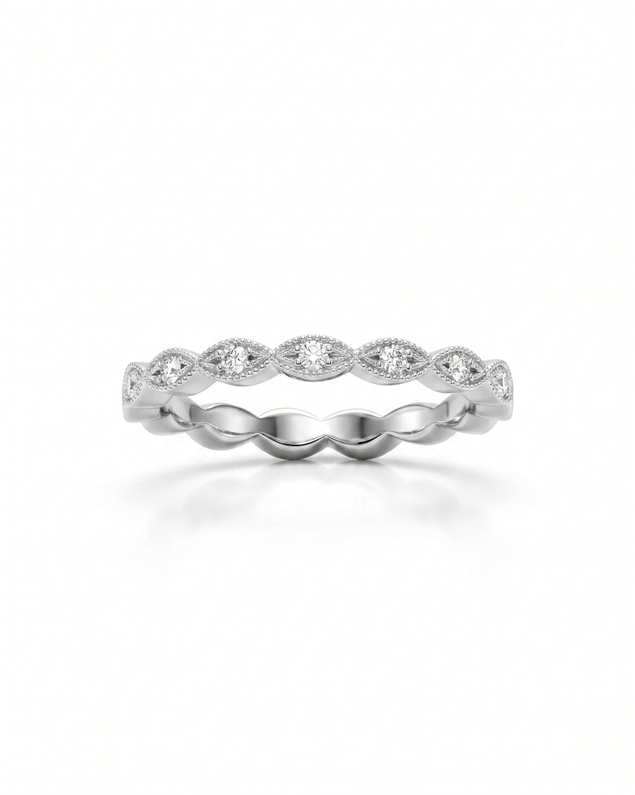 Silver marquise diamond ring with a scalloped band.