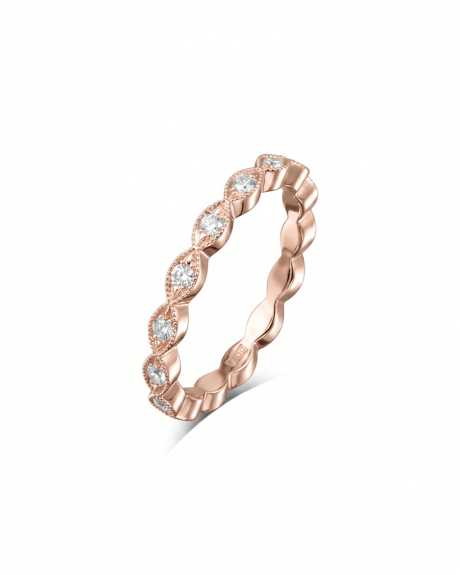Rose gold eternity ring featuring marquise-shaped settings with round diamonds and milgrain detailing.