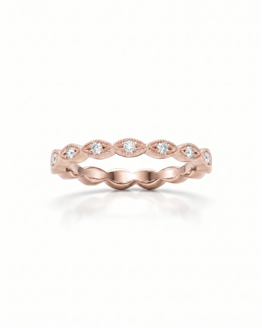 Rose gold eternity band with marquise-shaped settings and round diamonds in a vintage milgrain style.