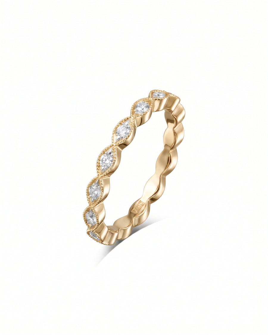 Yellow gold eternity ring featuring marquise-cut diamonds in a vintage milgrain setting.