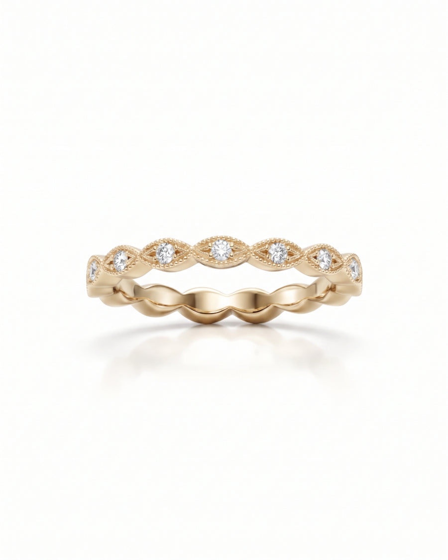 Yellow gold band featuring a series of marquise-shaped settings with small round diamonds and milgrain detailing.