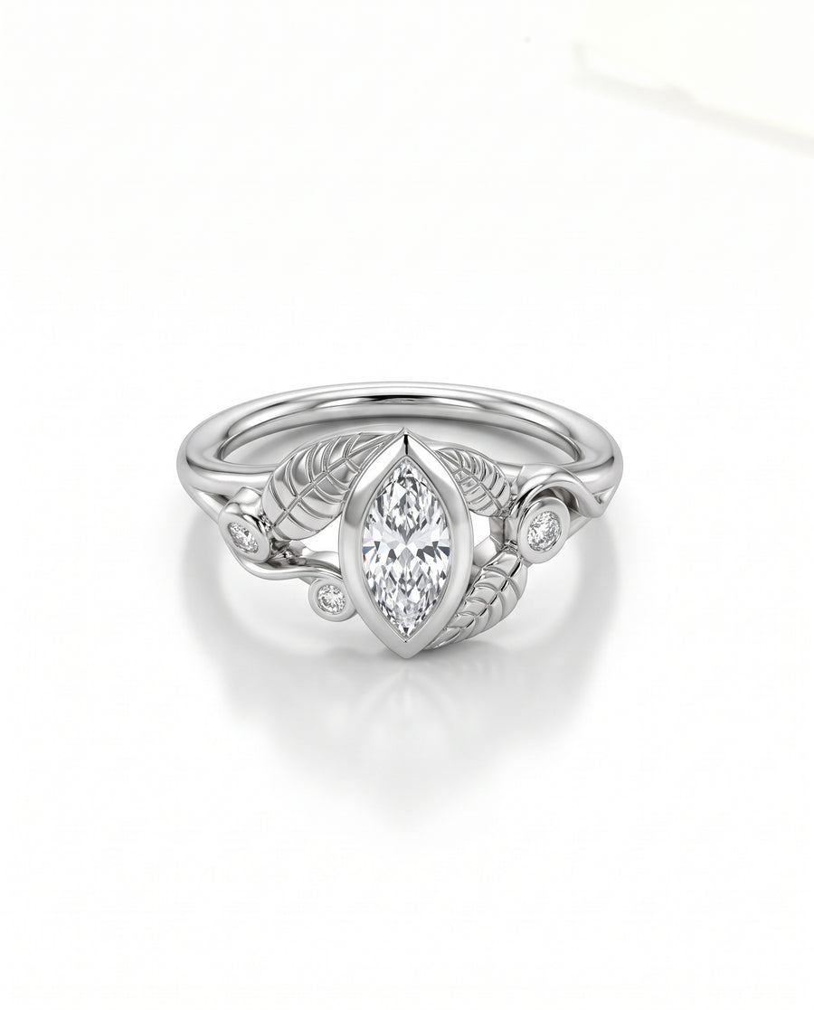 Marquise cut diamond engagement ring in silver with leaf-inspired metalwork and small round accent stones.