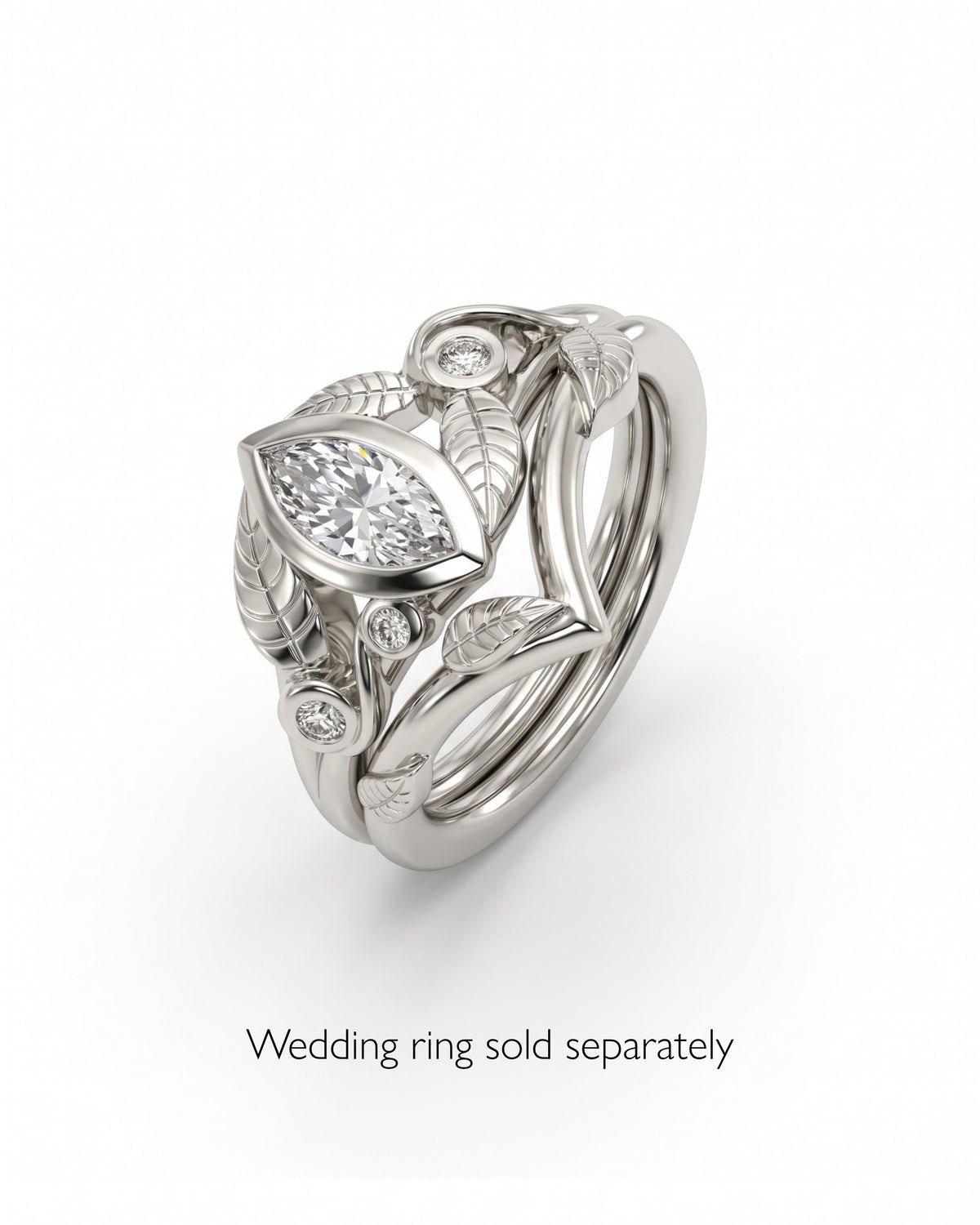 Silver engagement ring featuring a marquise-cut diamond and leaf-inspired metal detailing.