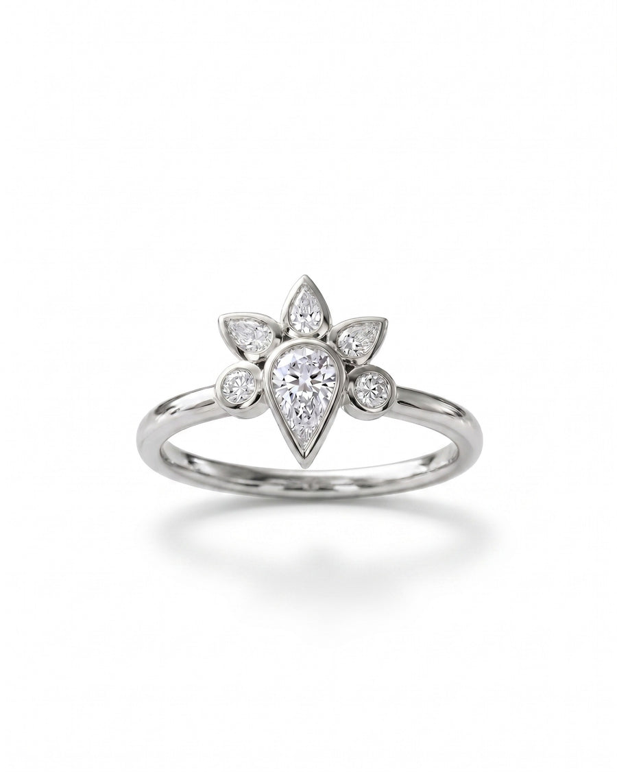 Silver ring with a pear-shaped diamond surrounded by smaller marquise and round diamonds in a peacock cluster design.