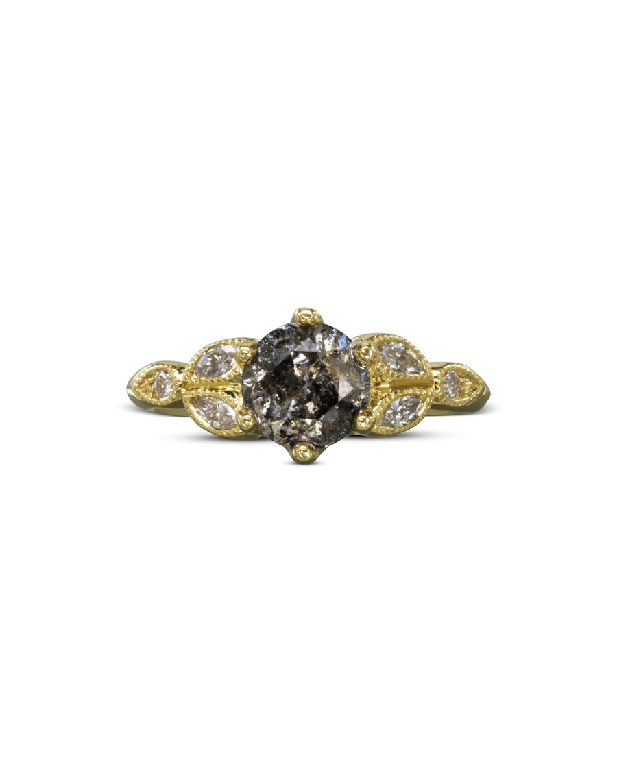 Gold engagement ring with a round salt and pepper diamond and marquise side stones.