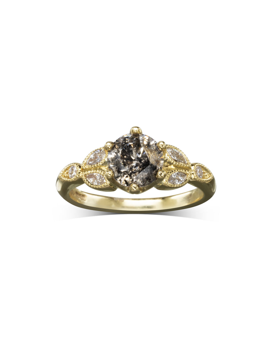 Gold engagement ring with a round salt and pepper diamond and marquise side diamonds.