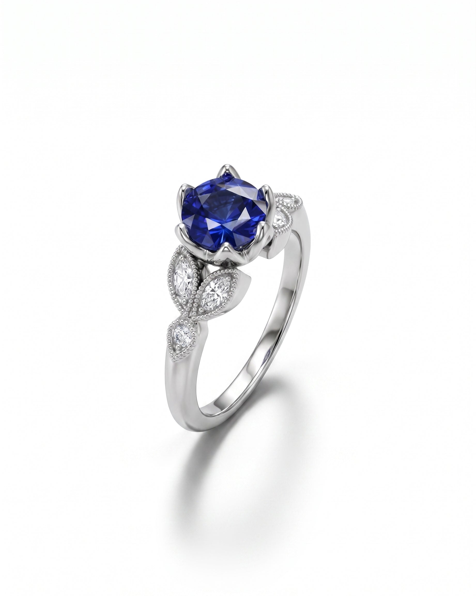 White gold ring with a large oval sapphire and marquise diamonds.