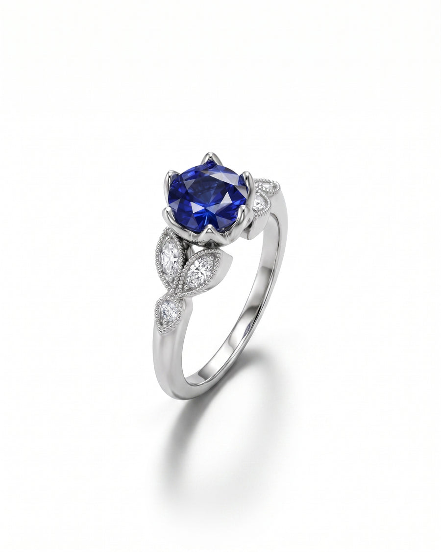White gold ring with a large oval sapphire and marquise diamonds.