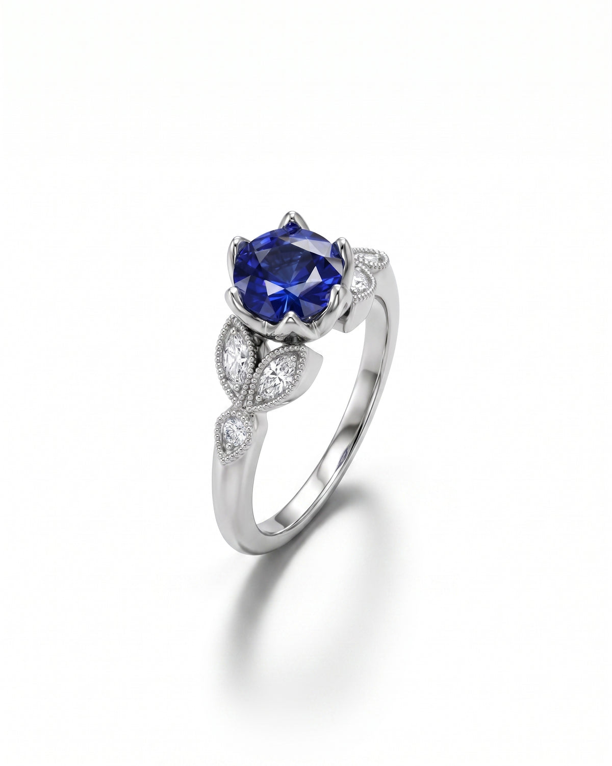 White gold ring with a large oval sapphire and marquise diamonds.