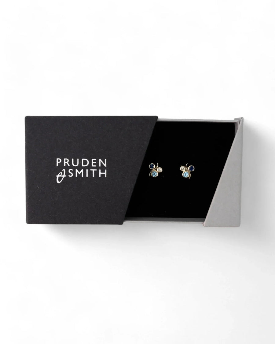 Yellow gold stud earrings with blue sapphire and water bubble design in a gift box