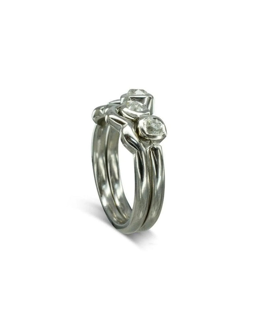 Silver wedding band with three water bubble shaped diamonds.