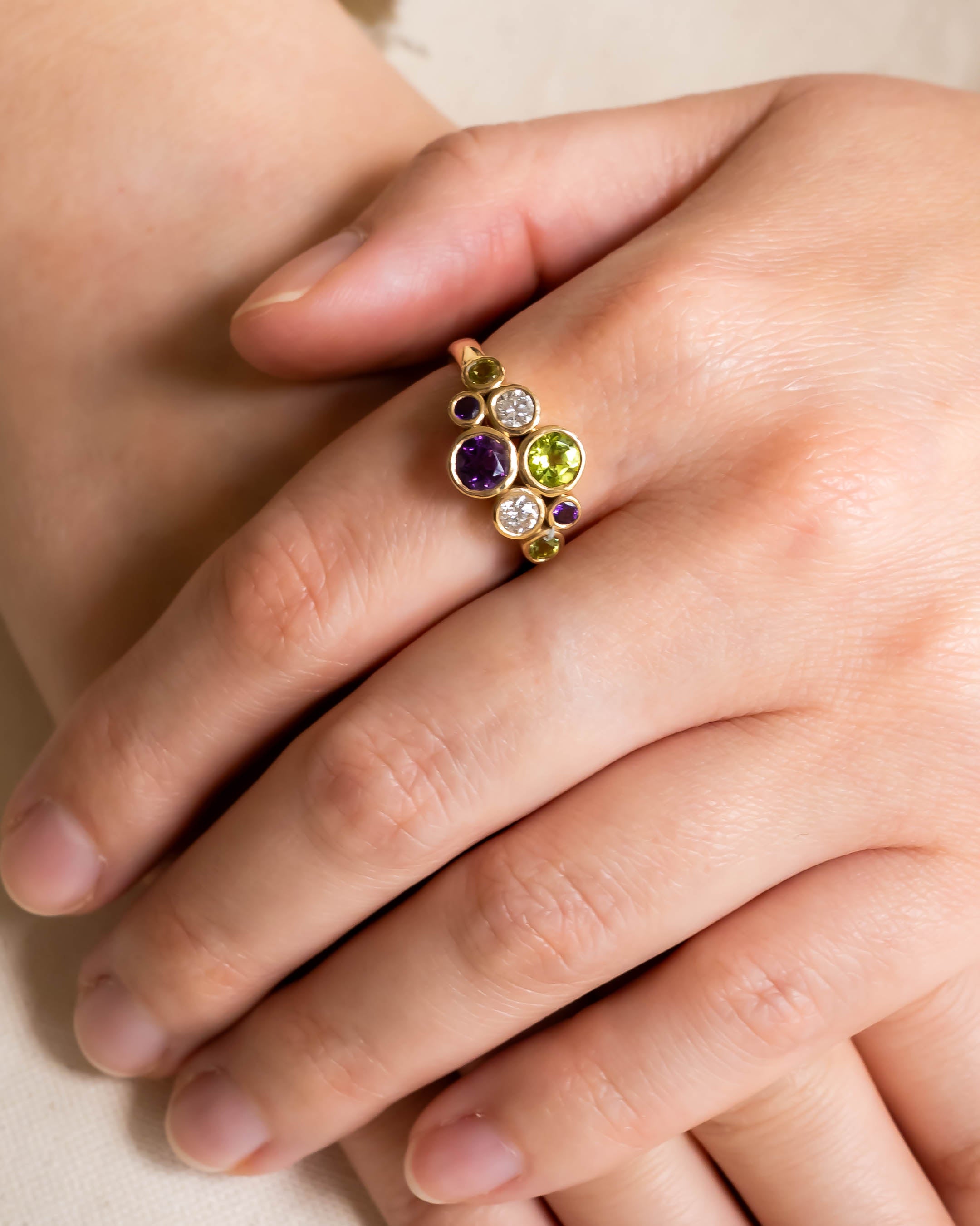 9ct yellow gold ring with round amethyst, peridot, and diamond gemstones.