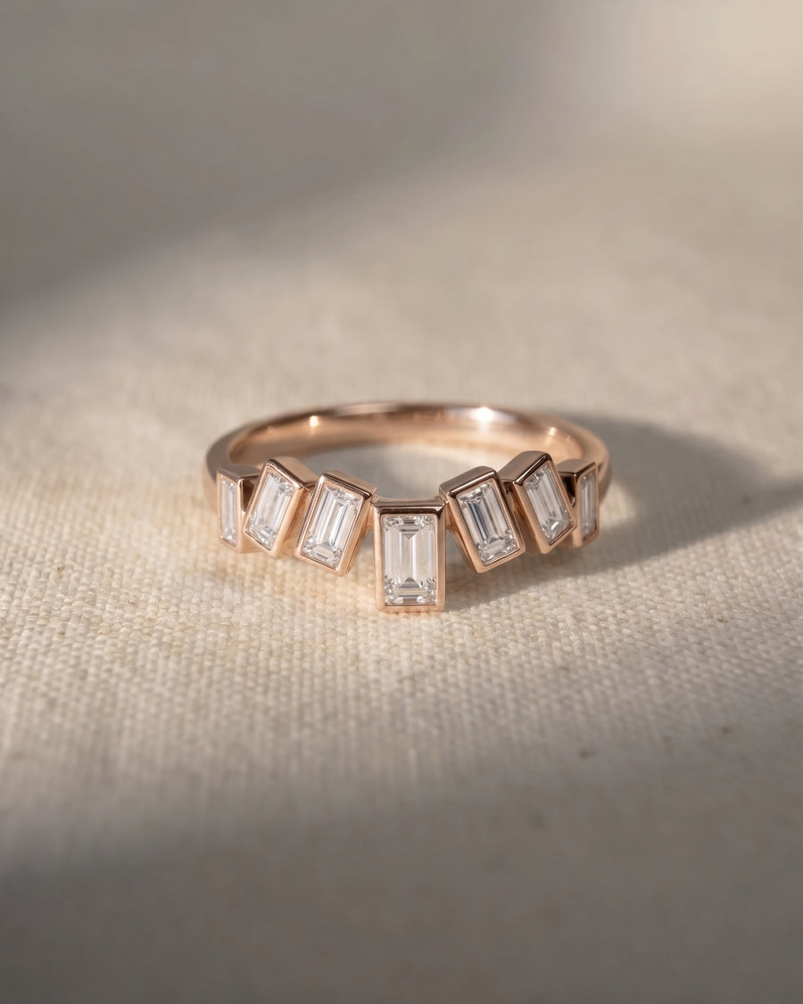 9ct rose gold curved ring with wave-set baguette diamonds.