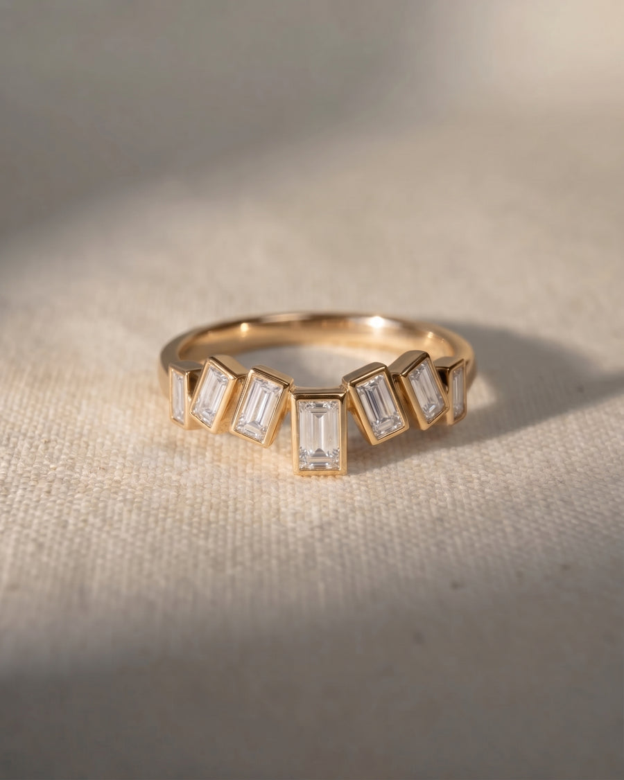 9ct yellow gold curved ring with baguette diamonds.