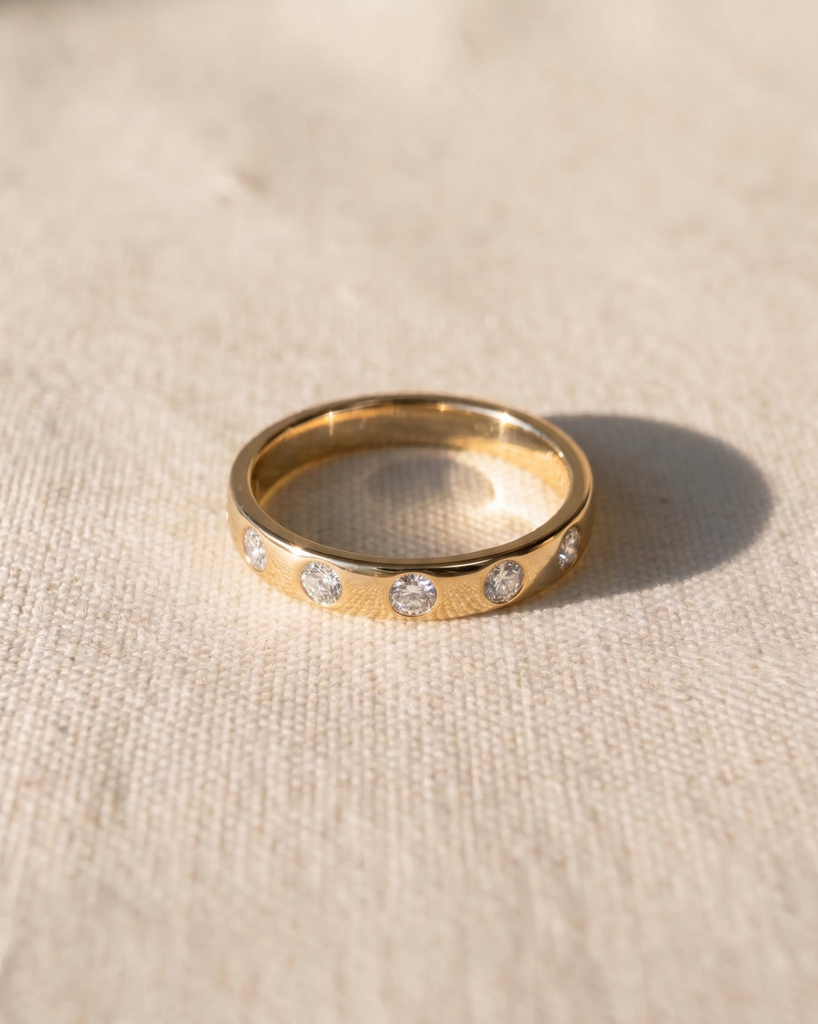 9ct yellow gold wedding ring with flush set diamonds.