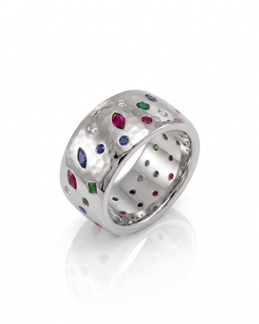 Platinum 12mm hammered ring with scattered sapphire, emerald, ruby, and diamond gemstones.