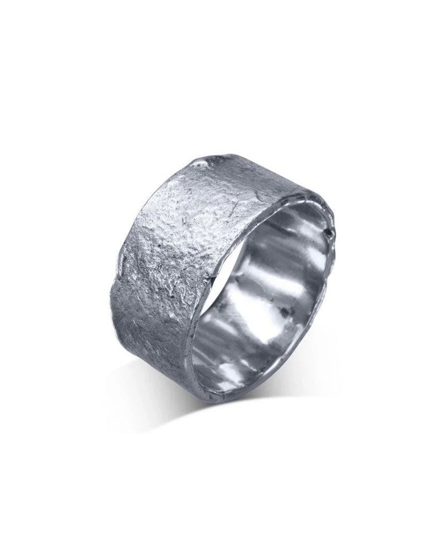 Wide silver wedding band with a textured, organic hammered finish on a white background
