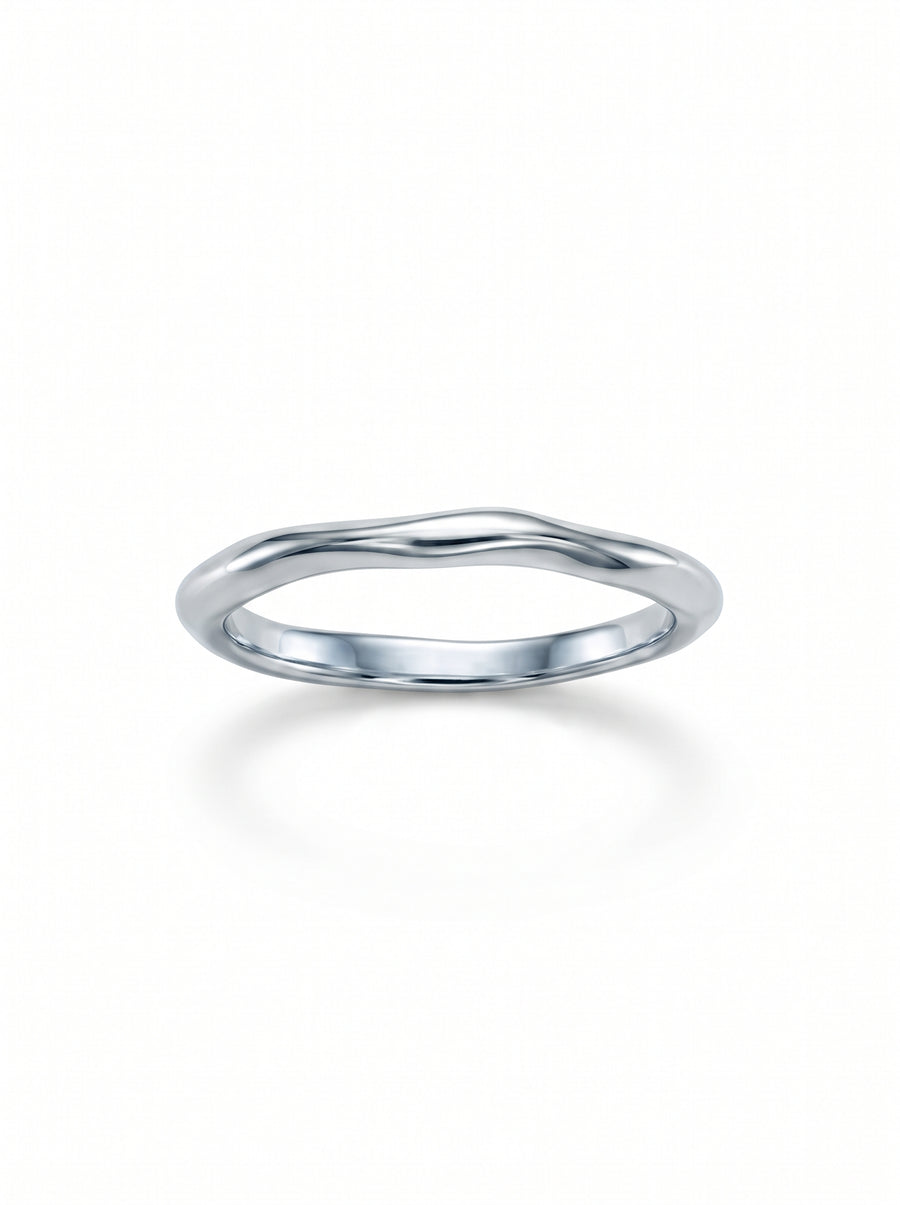 Dainty silver wedding ring with a smooth, uneven organic wave design on a white background.