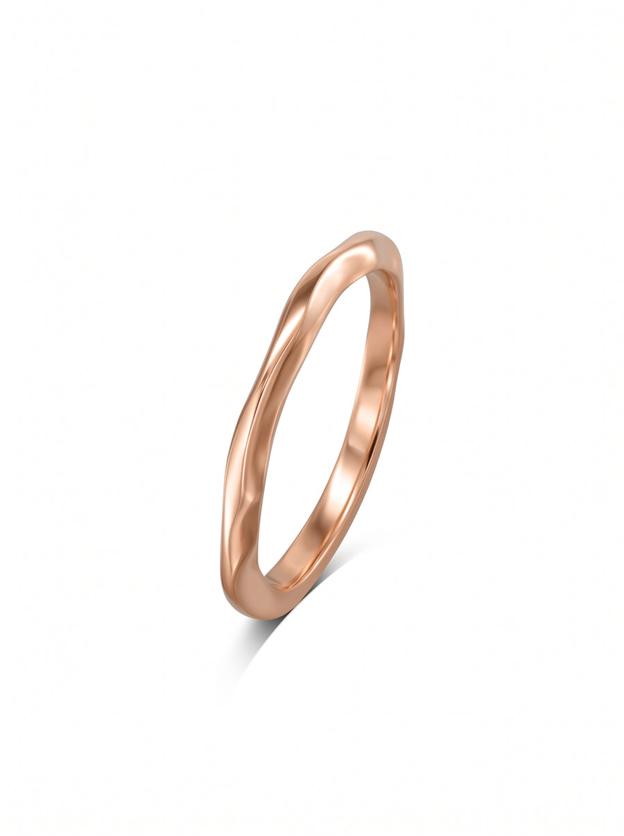 Dainty rose gold wedding ring with a smooth, uneven wavy band design.