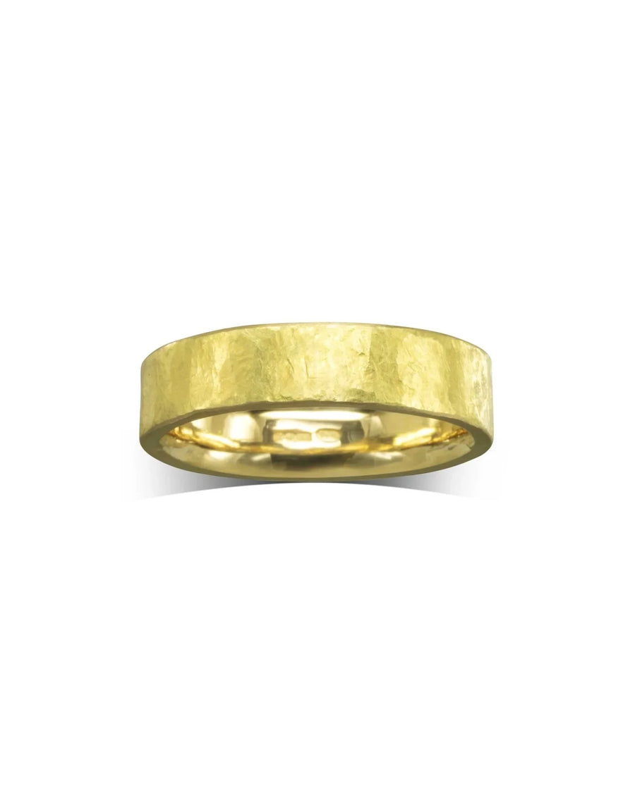 Rough hammered yellow gold wedding band.