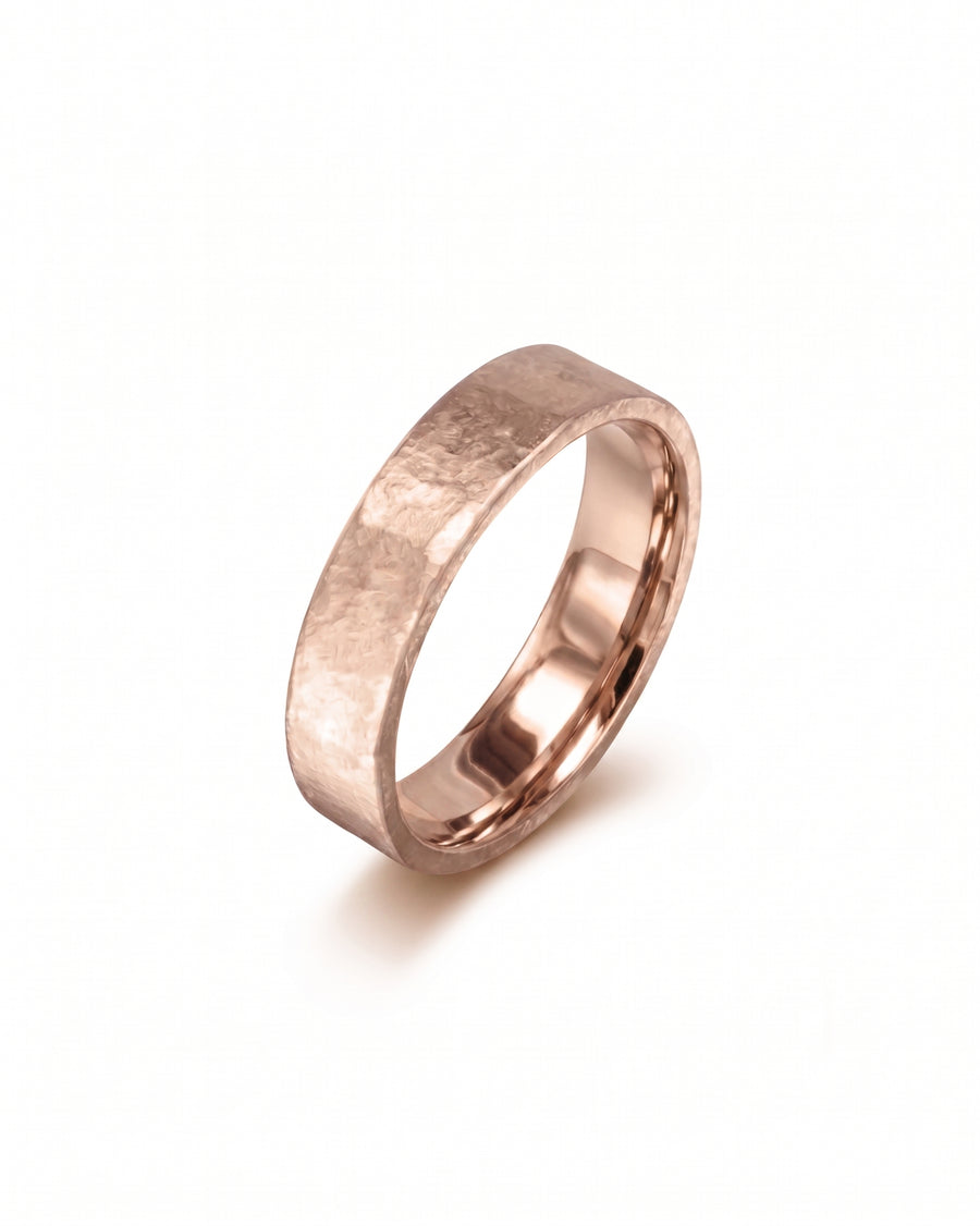 Rough hammered yellow gold wedding band.