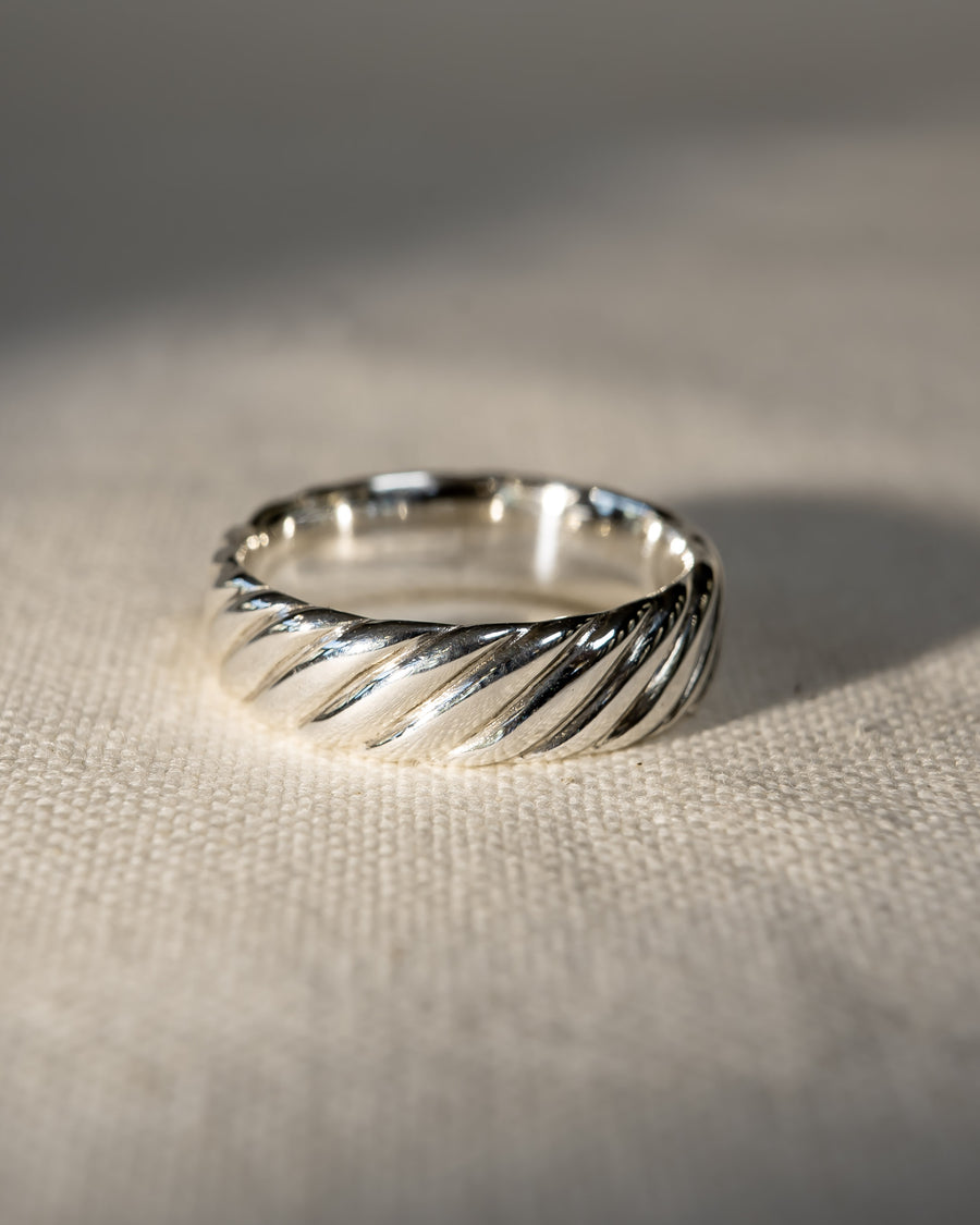 Silver twist wedding ring with a polished finish.