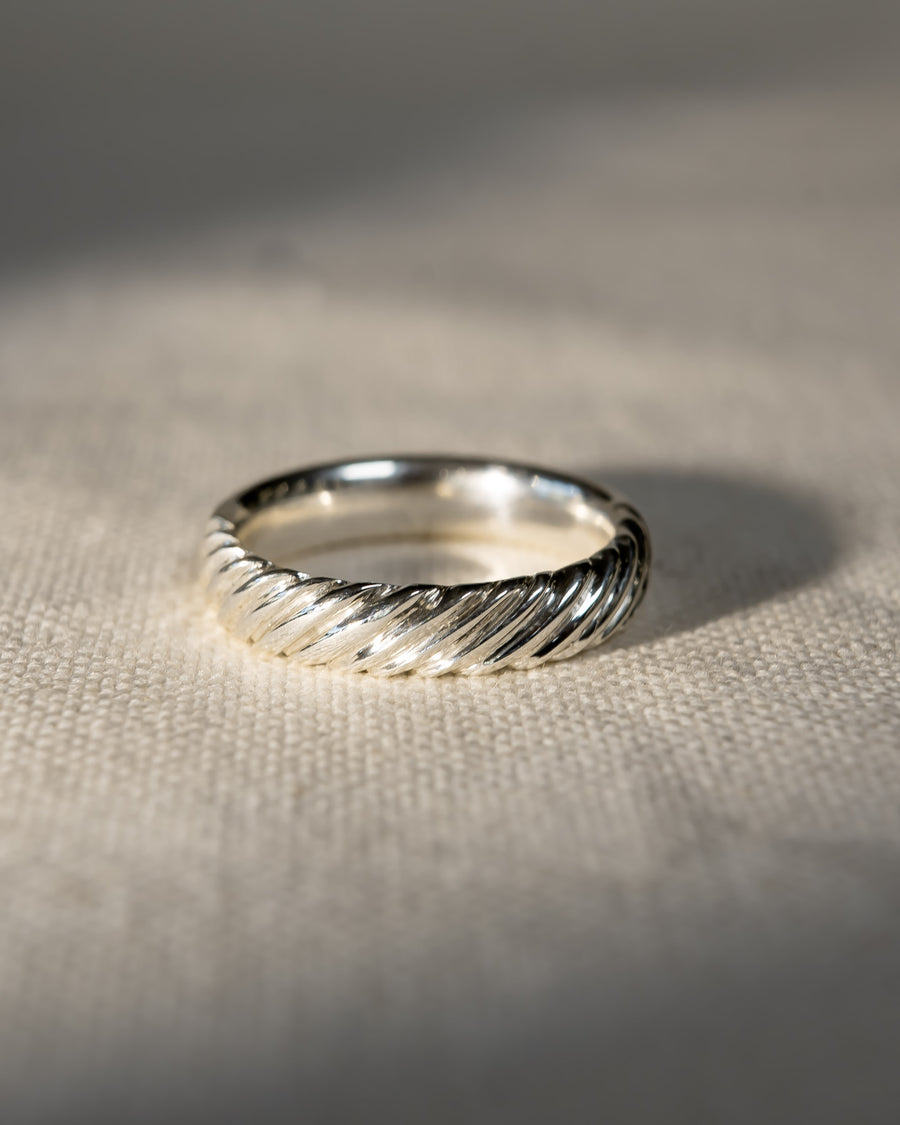 Silver twist wedding ring with a textured band.