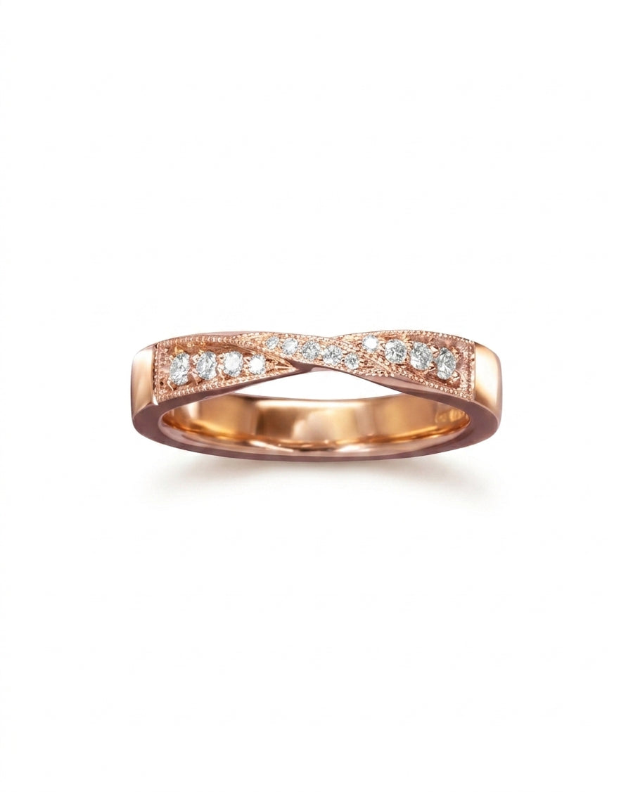 Rose gold twist diamond ring with milgrain edges.