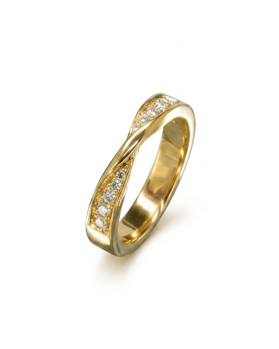 Gold wedding ring with a twisted band and pavé diamonds.
