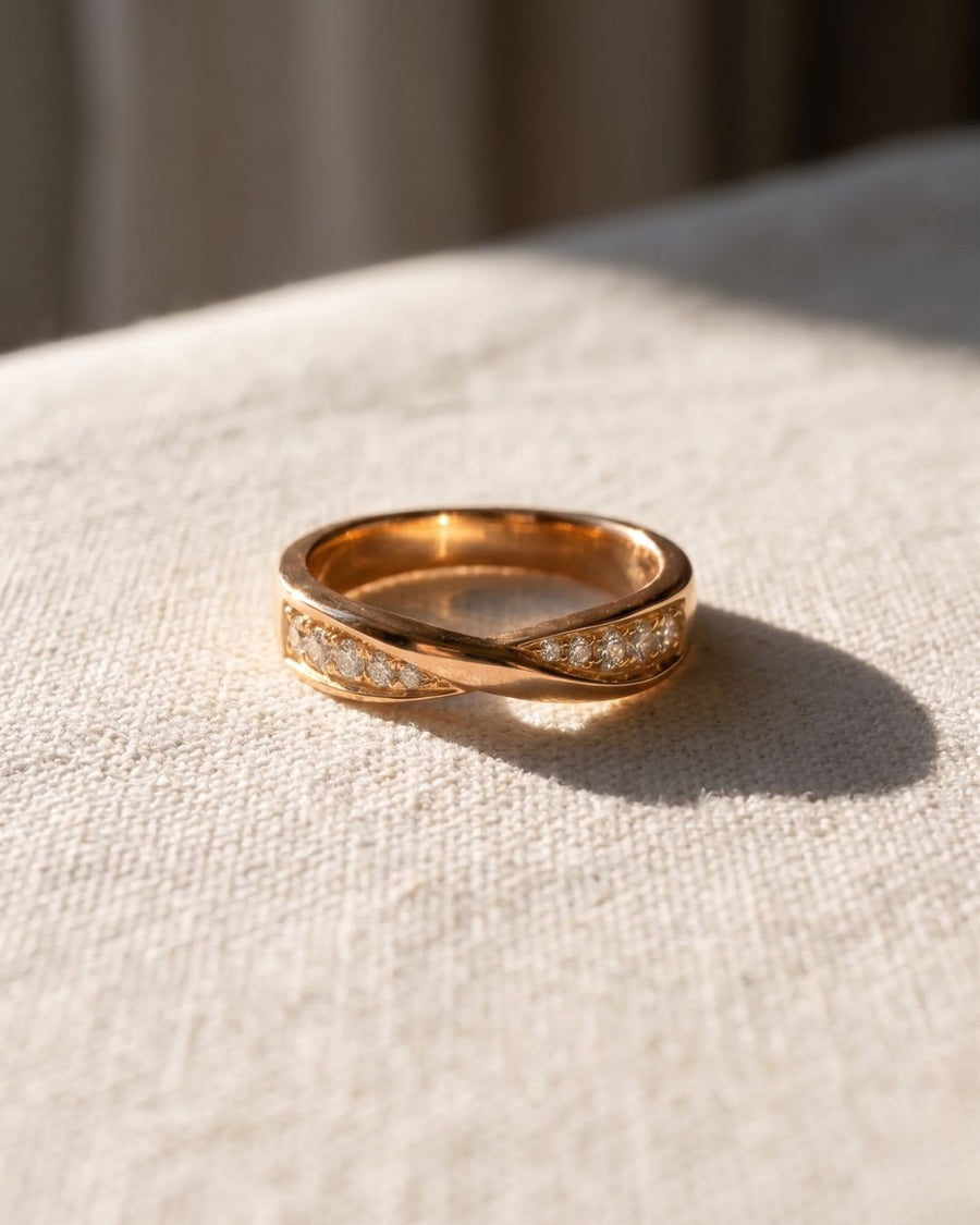 9ct rose gold wedding ring with a twisted design and four diamonds.