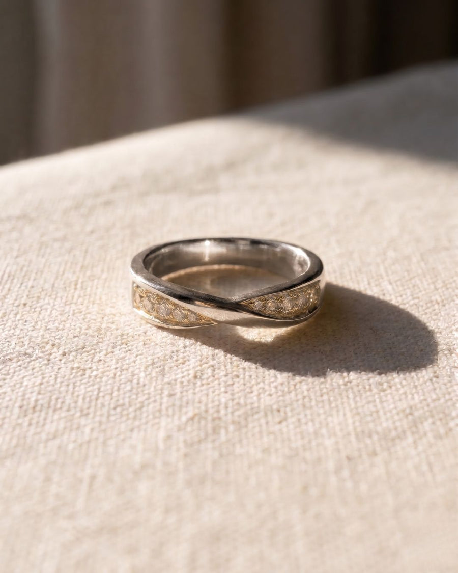 9ct white gold wedding ring with a twisted band and four diamonds.