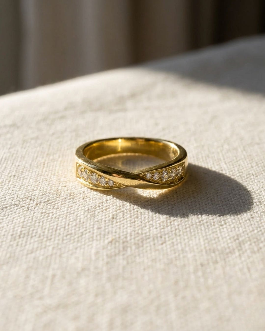 9ct yellow gold wedding ring with a twisted band and four diamonds.