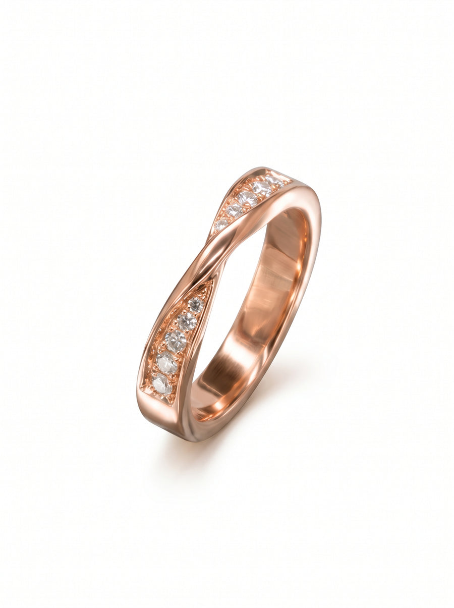 Rose gold wedding ring with a twisted band and channel-set round diamonds on a white background.